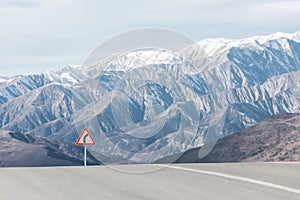 Turn sign on a mountain winding road