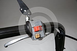 turn signal button on the scooter handlebar. horn button on the motorcycle handlebar.