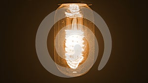 Turn on and turn off in slow motion, retro vintage light bulb with old technology with filament built-in with warm light yellow