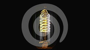 Turn on and turn off in slow motion, retro vintage light bulb with old technology with filament built-in with warm light yellow