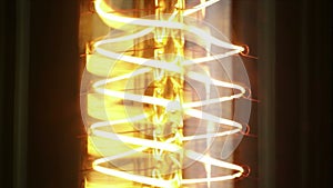 Turn on and turn off in slow motion, retro vintage light bulb with old technology with filament built-in with warm light yellow