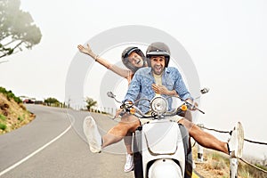 Turn your journey into a high-powered thrill ride. an adventurous couple out for a ride on a motorbike.