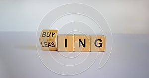 Turned a cube and changed the word `leasing` to `buying`, or vice versa. Beautiful white background. Business concept. Copy sp