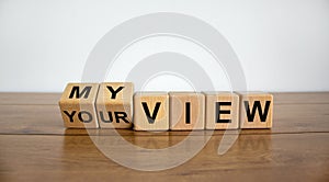 Turned cubes and changed the words `your view` to `my view` or vice versa on wooden cubes. Beautiful wooden table, white photo