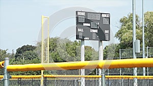 turned off baseball electronic digital scoreboard on posts in outfield with time 131 v