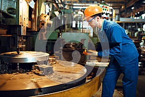 Turner stanging at the automated lathe, factory