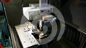 Turners and millers work at machines. The machines are turning out parts. Milling and lathe machines in a workshop in a factory.