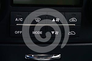 Turning on the air conditioning of a car on the climate control panel