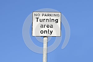 Turning area only no parking sign against blue sky