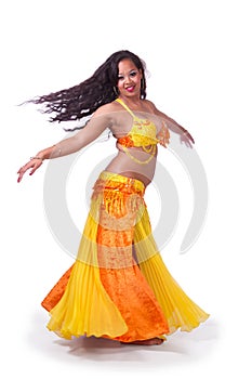 Turning bellydancer in yellow and orange