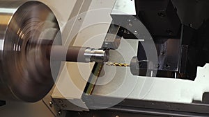 Turning bench lathe machine milling metal rod piece - closeup