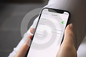 Turning on the Bluetooth settings on mobile phone, setting screen close-up, person using bluetooth