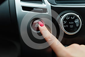 turning on car air conditioning system,finger hitting car emergency light botton