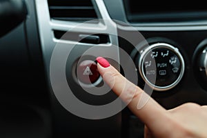 turning on car air conditioning system,finger hitting car emergency light botton