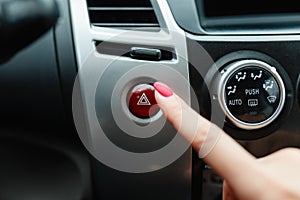 turning on car air conditioning system,finger hitting car emergency light botton