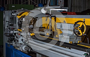 Grey and yellow turning lathe