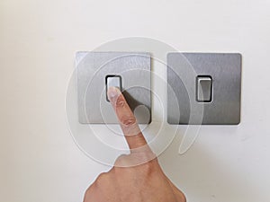 Turning On Modern Electric Switch With Finger. Selective Focus