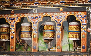 Turning prayer wheels mantra in Bhutan with traditional writing mantra which sounds as Om mani padme hum, literally means Oh, jewe