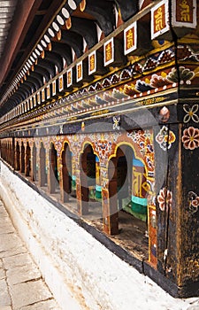 Turning prayer wheels mantra in Bhutan with traditional writing mantra which sounds as `Om mani padme hum`, literally means Oh, je photo