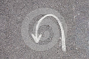 Turning sign on road. Turn back asphalt road texture background