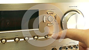 Turning up or down the volume on a av receiver , close up