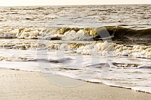 Turning waves on the beach of Katwijk Netherlands