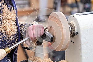 Turning a wooden part on a lathe. Carpentry work. Mechanical woodworking