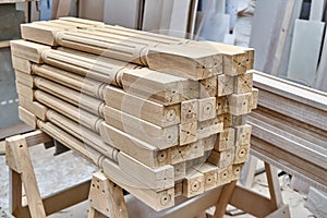 Turning wooden stair balusters. Wood stair balusters stacked in workshop