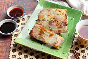 Turnip cake in Chinese called Lo Bak Go - Chinese food on the wooden background at top view