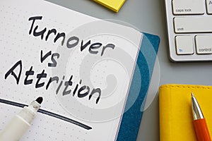 Turnover vs attrition words in the notepad and marker.