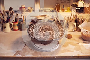 Turntable For Decorating Handmade Pottery On Workbench In Ceramics Studio