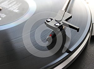 Turntable head on black vinyl disc top view detailed stock photo