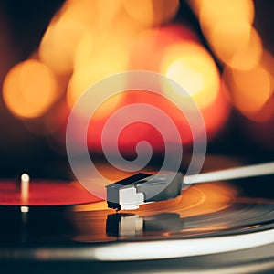 Turntable with LP vinyl record against fire background