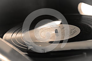 Turntable, Old record player stylus on a rotating disc, vintage filtered, selective focus