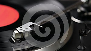 Turntable player with black vinyl record, stylus and turntable. Macro shot
