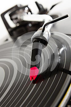 Turntable playing vinyl record with music