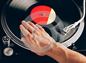 Turntable scratch, hand of dj on the vinyl record