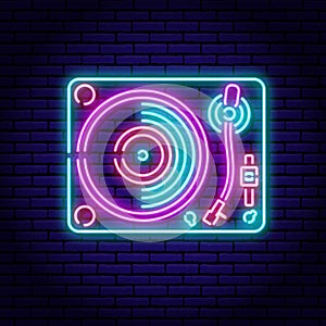 Turntable, vinyl record player. Neon sign on a brick wall background.