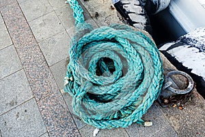 Turqoise rope piled on a dock