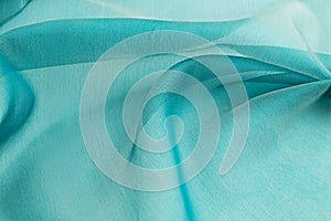 Turquoise background luxury cloth or wavy folds of grunge silk texture satin