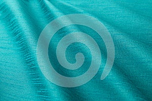 Turquoise background luxury cloth or wavy folds of grunge silk texture satin