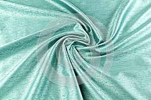 Turquoise background luxury cloth or wavy folds of grunge silk texture satin