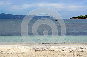 Turquoise bay and moored sailing boat