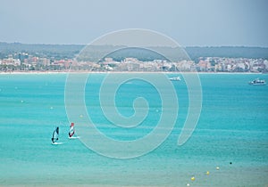 Turquoise bay with windsurfers