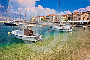 Turquoise beach and harbor of Postira village