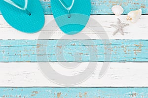 Turquoise beach sandals with sea star and seashells for summer holiday travel background