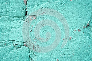 Turquoise blue brick wall detail texture background. Old, painted, weathered and cracked stone bricks with concrete and stucco