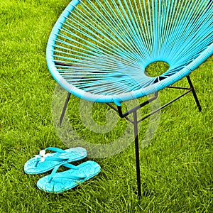 Turquoise blue garden chair and flip flops