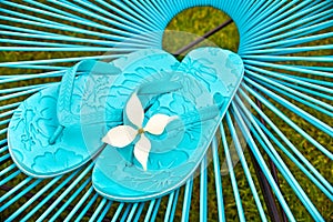 Turquoise blue garden chair and flip flops