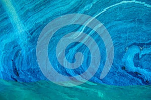 Turquoise blue lines on marble rock formation at Marble caves or Cuevas de Marmol at turquoise General Cerrerra Lake. Location